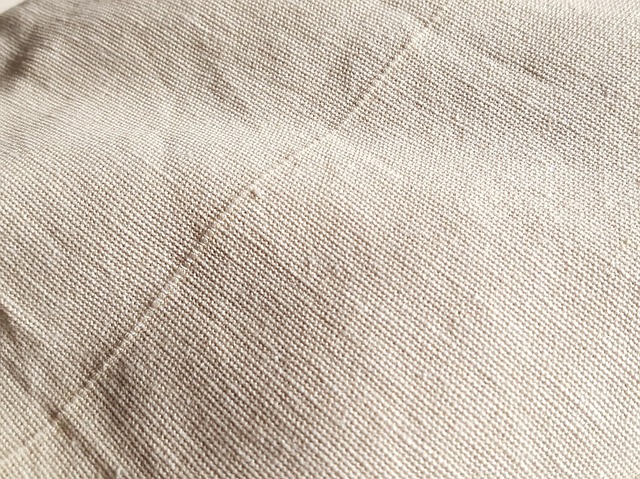 linen textiles and neutral cushions on a warm minimal sofa